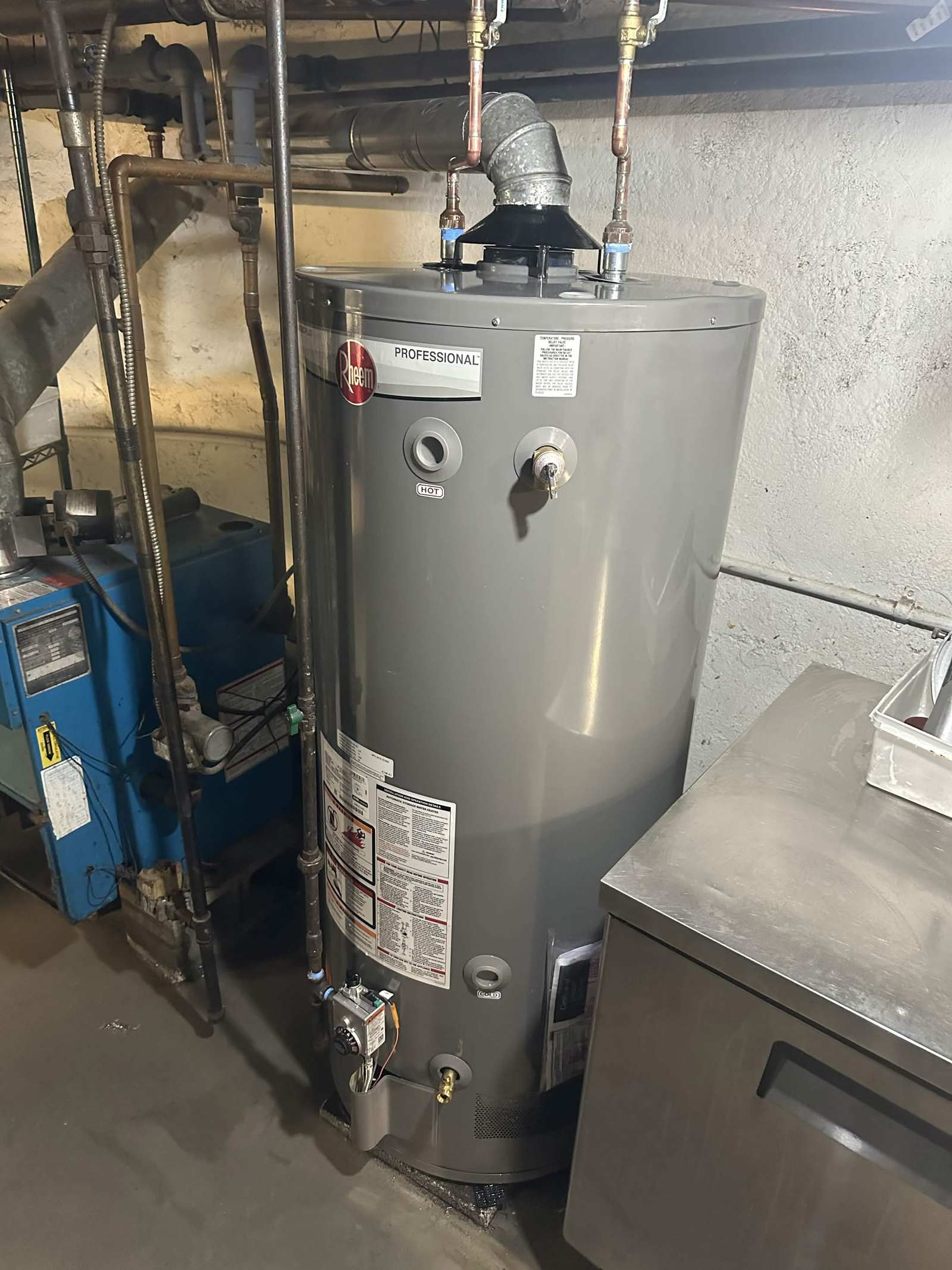 New gas water heater installed in a basement.